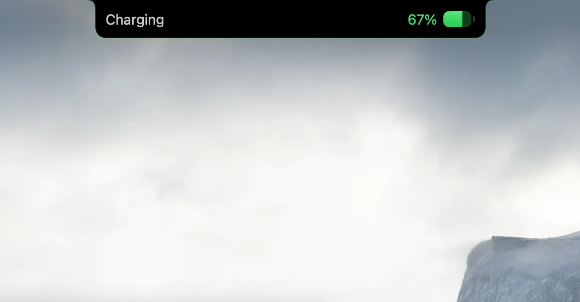 A compact NotchMind charging notification showing 67 percent with a green battery icon.