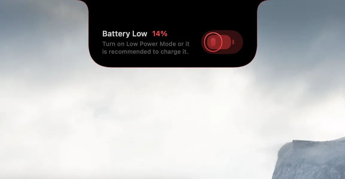 A NotchMind low-battery notice showing 14 percent and suggesting charging or Low Power Mode.